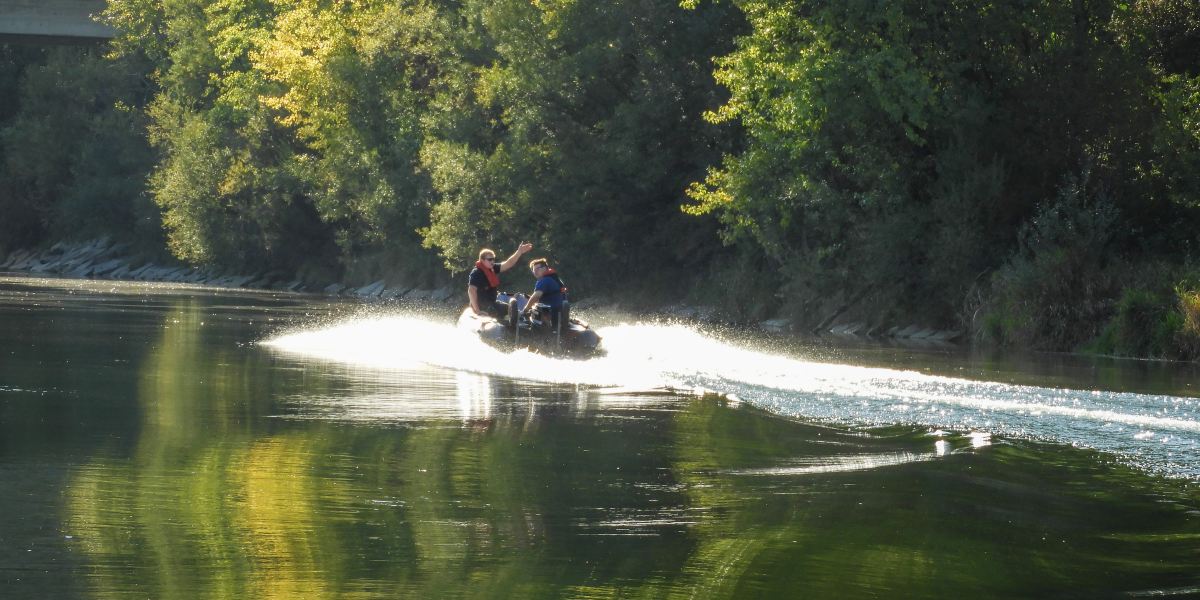 Taucher und Schiffsführer üben auf und unter dem Wasser der Traun